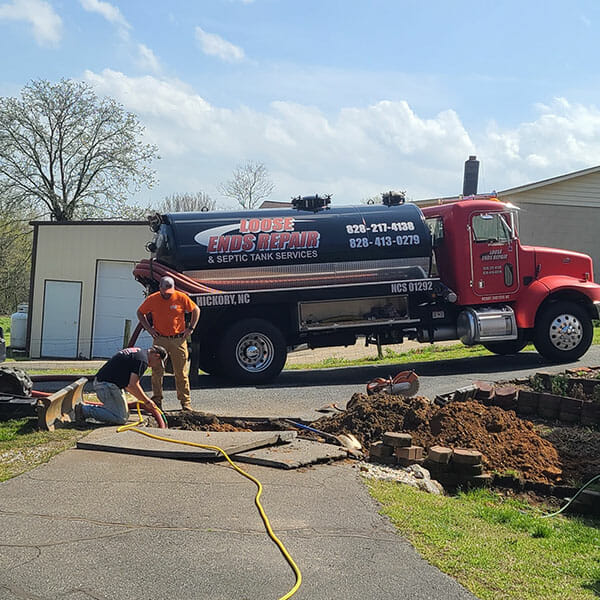 Workers inspecting a septic system