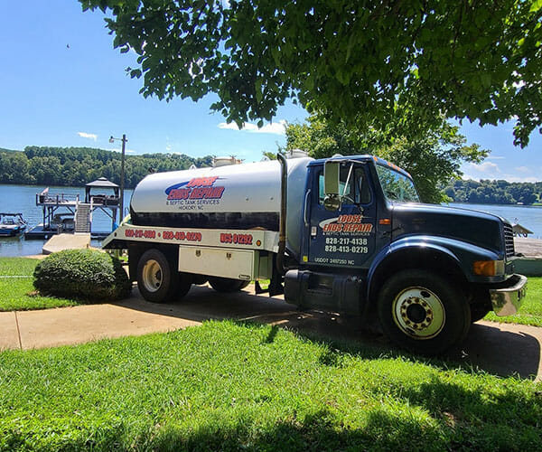 Loose ends work truck in front of lake